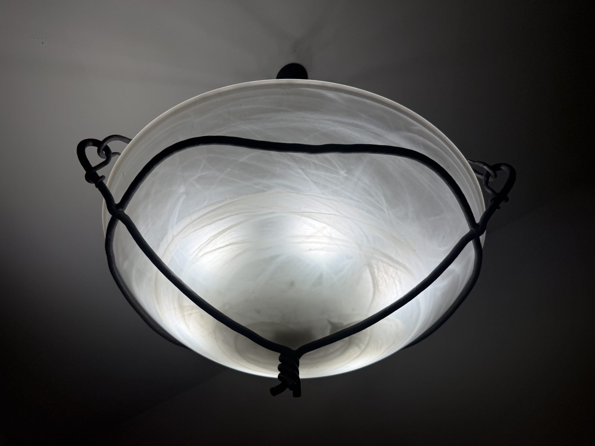 Hand-blown glass shade in a hand-forged iron cradle — built to order