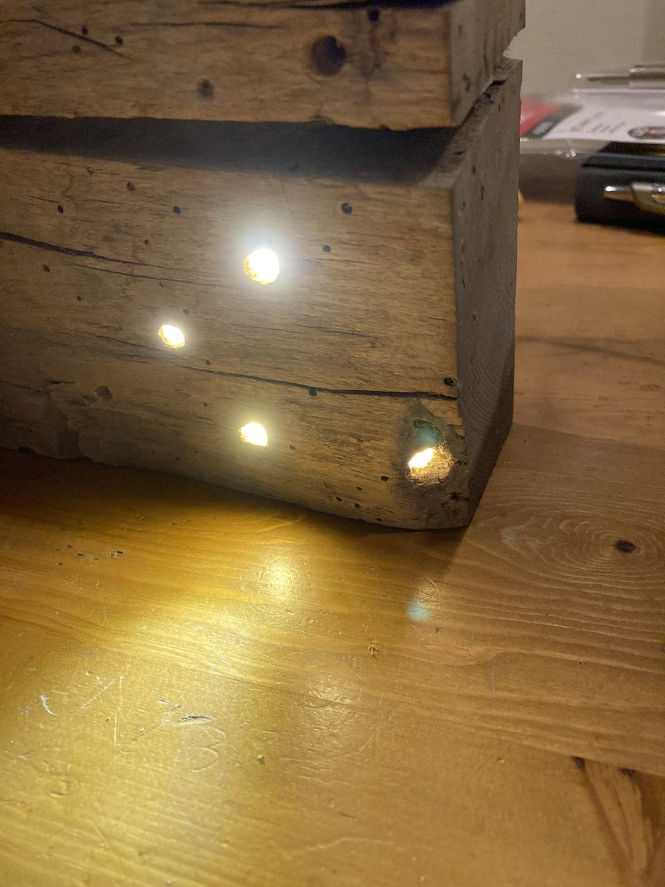 Pinpoint LEDs set into a reclaimed timber beam